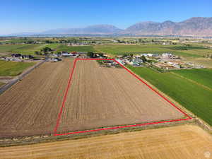 Overview of rural landscape with property boundaries highlighted, abundant farmland, and a mountainous background