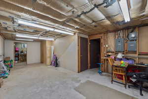 Unfinished basement with electric panel