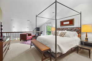 Bedroom with carpet floors and vaulted ceiling