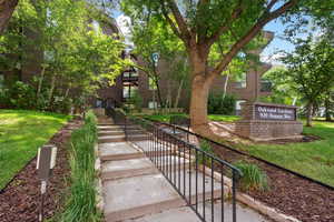View of property's community with a yard and stairs