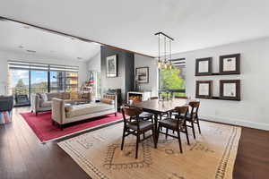 Dining room featuring plenty of natural light, hardwood / wood-style floors, baseboards, and lofted ceiling