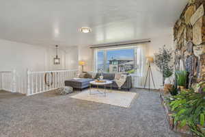 Living room with carpet flooring, and bay windows