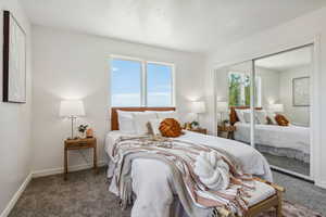Primary bedroom with lots of natural light and a closet