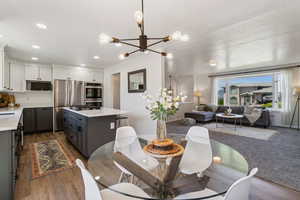 Dining space featuring a chandelier, recessed lighting, wood finished floors, and baseboards