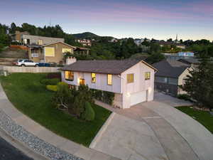 View of front of property featuring a garage, driveway, and a residential view