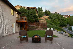 View of patio / terrace with an outdoor fire pit, a wooden deck, and stairs