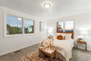 Primary bedroom with sunset views