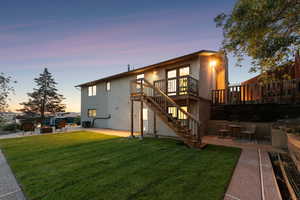 Rear view of house with stairway, a patio area, a wooden deck, and a fire pit