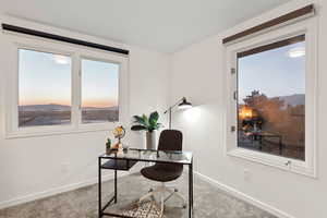 Home office/bedroom  featuring sunset views