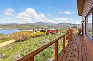 Wooden terrace with a water and mountain view