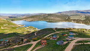 View of property location with a water and mountain view