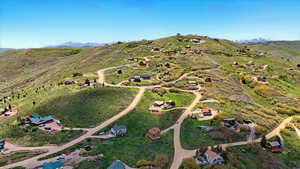 Aerial overview of property's location featuring a mountain backdrop