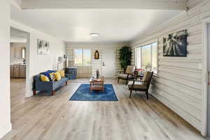 Living area with a wood stove, healthy amount of natural light, and light wood-style flooring