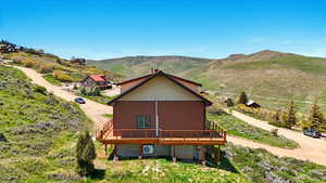 Back of house with a deck with mountain view