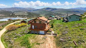 Aerial view of property and surrounding area featuring a water and mountain view