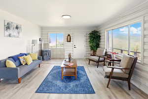 Living area featuring a wood stove and wood finished floors