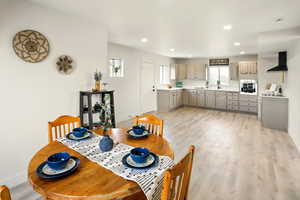 Dining room featuring plenty of natural light, light wood-type flooring, baseboards, and recessed lighting