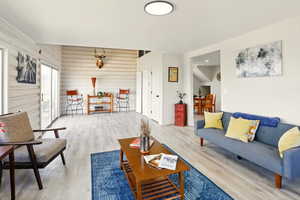 Living area featuring wood finished floors and wood walls
