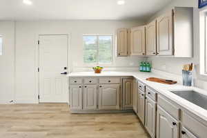 Kitchen with recessed lighting, light countertops, and light wood-style floors