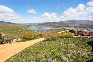 View of mountain backdrop featuring a nearby body of water
