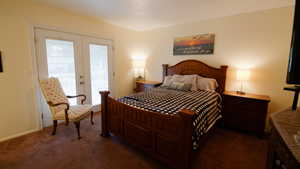 Bedroom featuring access to outside, carpet flooring, and baseboards