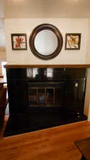Detailed view of wood finished floors and a textured ceiling