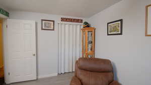 Living area with light wood-style floors and baseboards