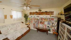 Sitting room with ceiling fan and carpet floors