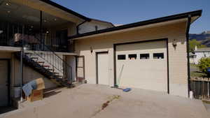 Garage featuring concrete driveway and a mountain view