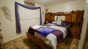 Bedroom with carpet floors and baseboards