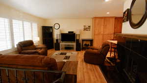 Living room featuring light wood-style flooring, healthy amount of natural light, and recessed lighting