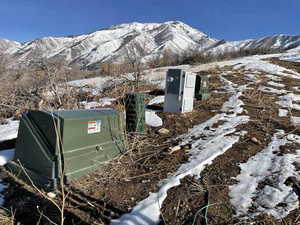 Exterior view of a pad mount transformer and a mountainous background
