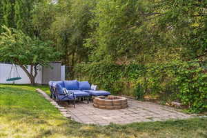 View of yard with a patio area and an outdoor living space with a fire pit