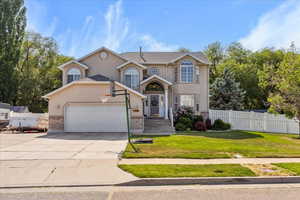 Traditional-style house featuring stucco siding, a garage, and concrete driveway