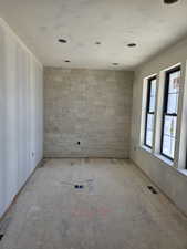 View of natural stone wall in living room.