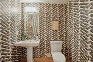 Bathroom with toilet and tile patterned floors