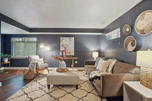 Living room with wood finished floors and baseboards