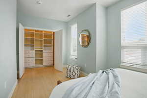 Bedroom with baseboards and light wood finished floors