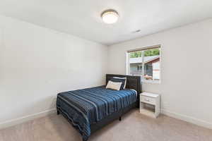 Carpeted bedroom with baseboards