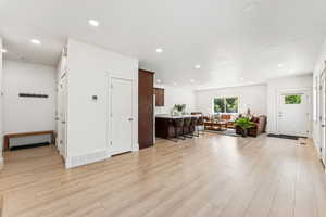 Foyer entrance featuring light wood-type flooring, recessed lighting, and baseboards