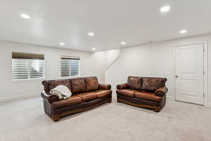 Living area featuring carpet, recessed lighting, and baseboards
