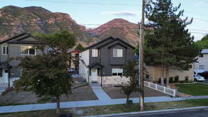 View of front of home featuring a mountain view and stone siding