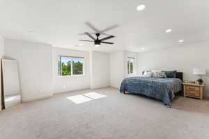 Bedroom with light colored carpet, baseboards, recessed lighting, and a ceiling fan