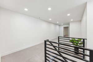 Hall with carpet floors, recessed lighting, and baseboards
