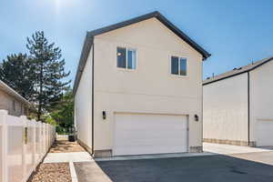 View of side of home featuring stucco siding and a garage