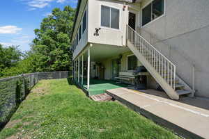 Walk out basement entrance, fenced yard, stairs coming down from sunroom