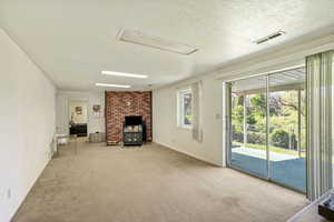 Open living room in basement with walk-out access and fenced yard.