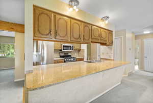 Main Floor Kitchen featuring stainless steel appliances, new granite countertops.