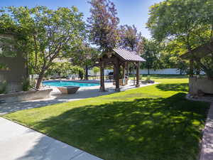 View of yard with an outdoor pool, a gazebo, and a patio