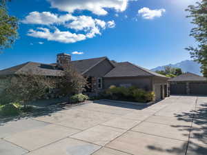 View of front of property, a mountain view, and Rock and stucco siding